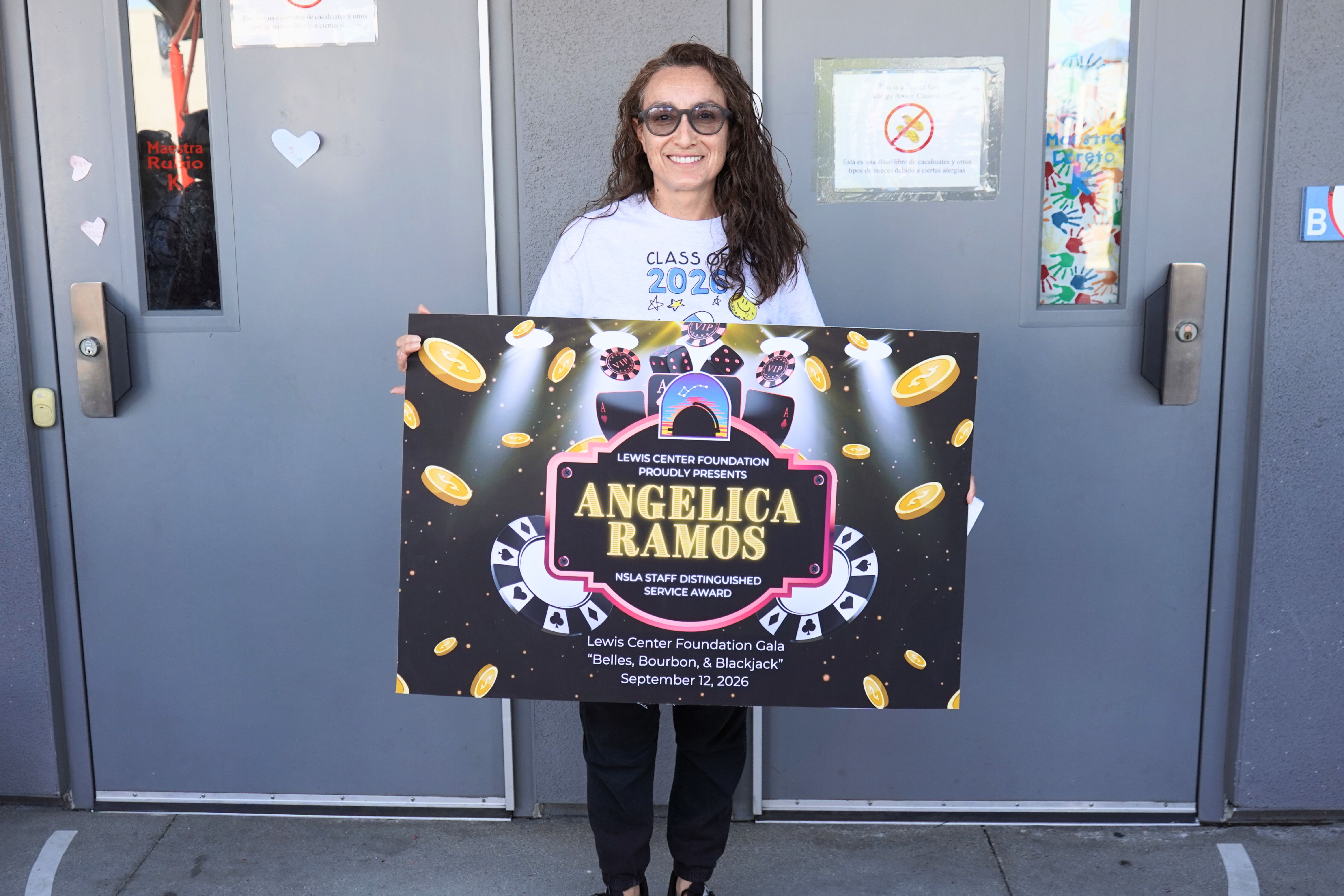 photo of Angelica Ramos holding 2026 Lewis Center Foundation Gala sign.