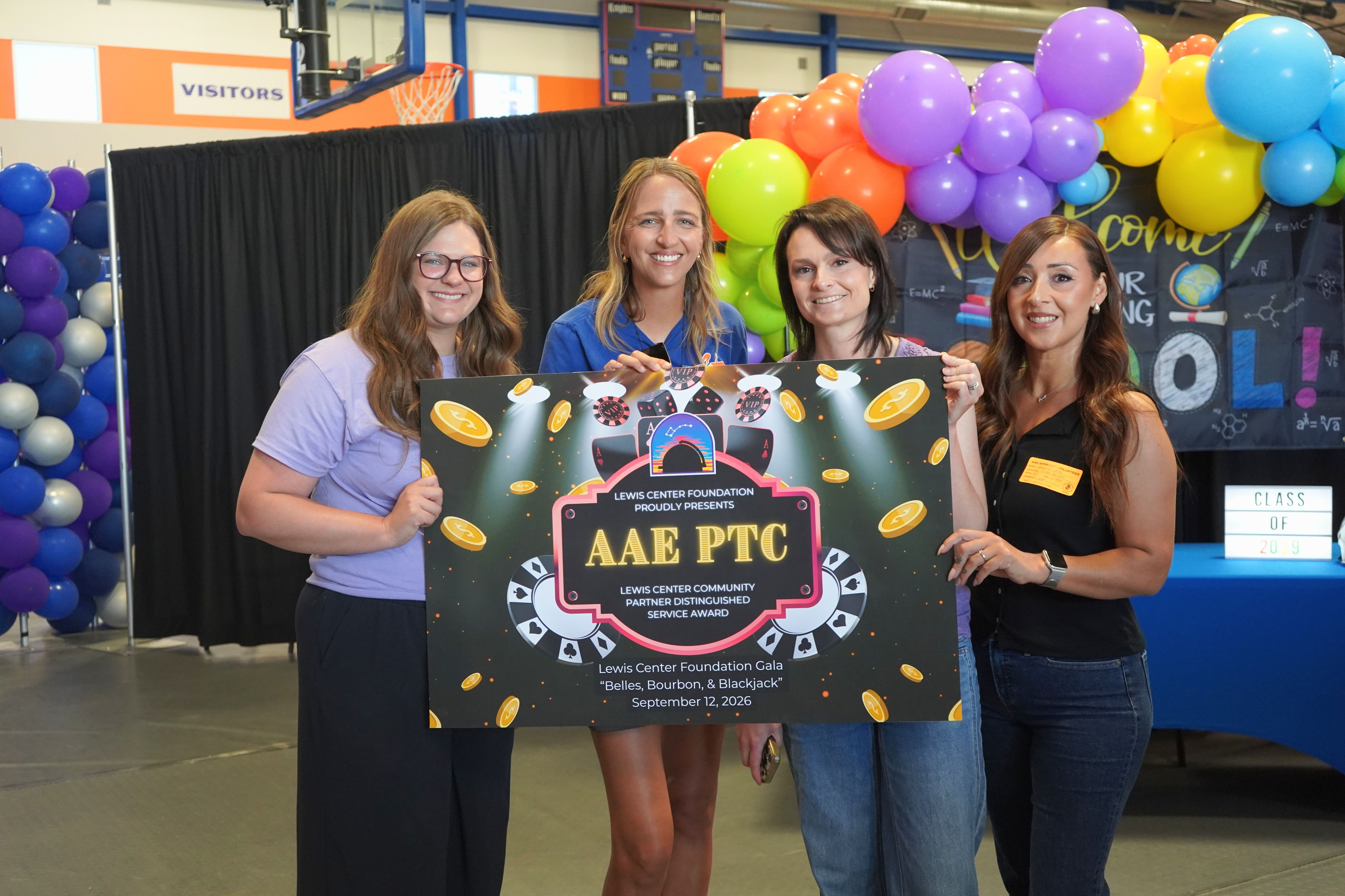 photo of AAE PTO holding 2026 Lewis Center Foundation Gala sign.